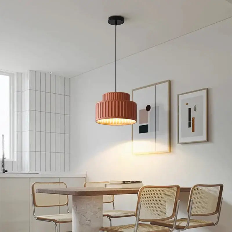 A warm-toned ribbed terracotta cream resin led pendant light with black ceiling mount for dining room decorbites cream resin