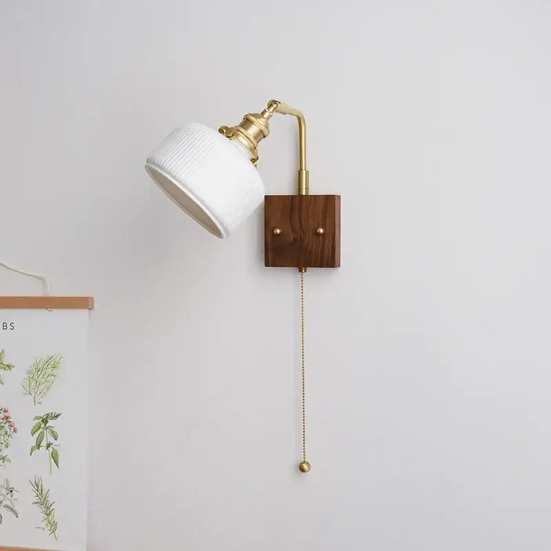 Ribbed white ceramic and copper led wall lamp with brass arm and wooden base featuring pull-chain switch for bedroom mirror light