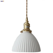 White ribbed ceramic pendant light fixture with brass socket and twisted cord featuring a brass knob switch for kitchen use