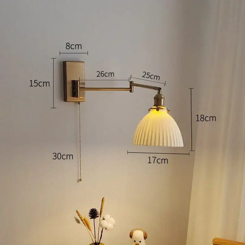Antique brass-finished wall sconce with cream ribbed glass shade brass swing arm decorbites brass swing for bedroom decor