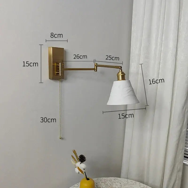 Gold-finished adjustable wall sconce with white marble-effect shade decorbites brass swing arm bedroom light
