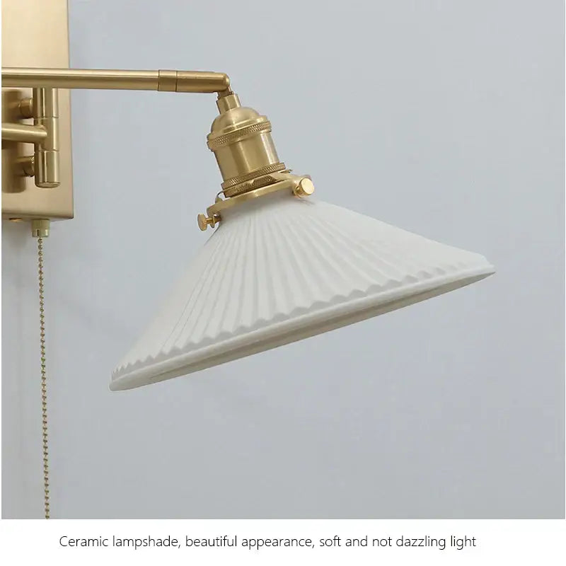 White ceramic wall sconce with fluted ribbed lampshade and brass swing arm from decorbites brass swing collection