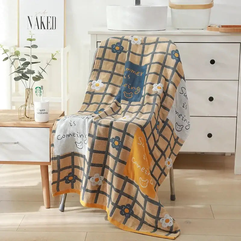 Romantic beige and black floral cotton bath towel with grid pattern and colorful summer is coming text for bathroom decor