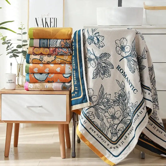 Romantic beige cotton bath towel with black floral embroidery and blue border for elegant bathroom decor