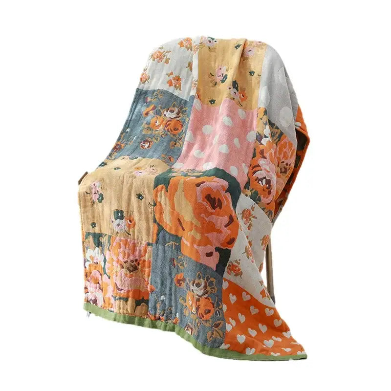 A soft cotton bath towel with a romantic beige and black floral design featuring a vibrant patchwork quilt pattern