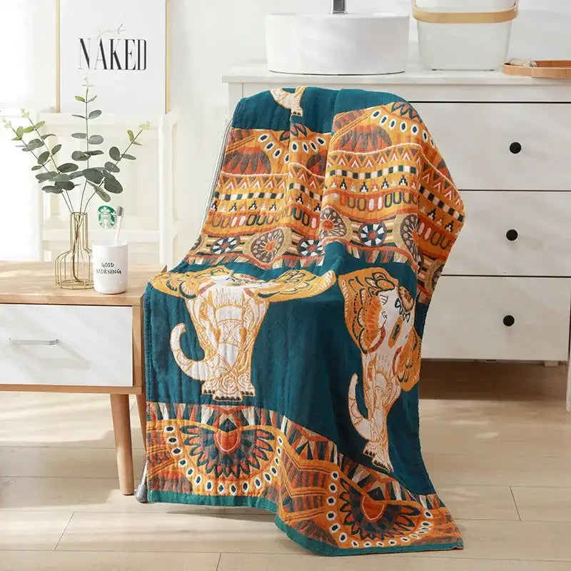 Romantic beige and black floral cotton bath towel with teal and orange patterned blanket featuring embroidered elephants
