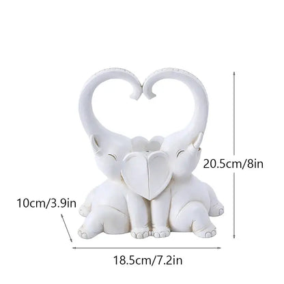 White resin decorbites elephant couple figurine with heart-shaped trunks and central heart motif for living room decor
