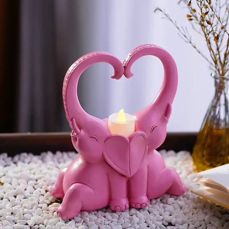 Pink resin romantic elephant couple candlestick with heart-shaped trunks framing flame for living room decorbites elephant couple