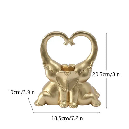 Golden resin decorbites elephant couple candlestick with elephants forming a heart holding a smaller heart decor piece