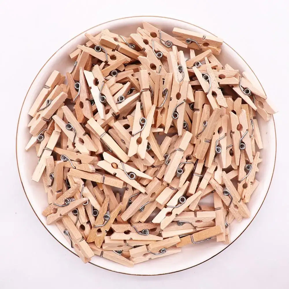 A pile of light brown wood clips with silver metal springs for romantic heart shape wood bedroom decor