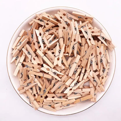 A pile of light brown wood clips with silver metal springs for romantic heart shape wood bedroom decor