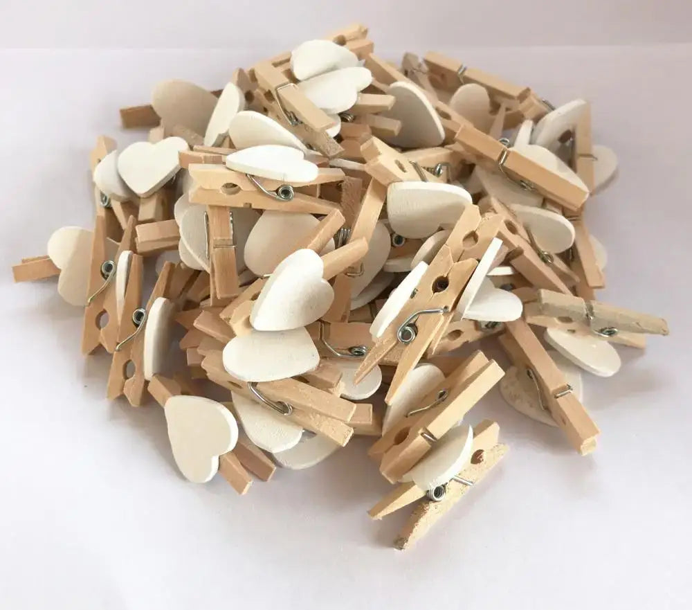 A pile of light wood romantic heart shape wood clips with white smooth-finished clips for multi color bedroom decor