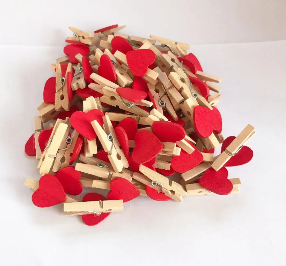 A pile of wood clips with red romantic heart shape felt attachments for multi color bedroom decor