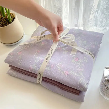 Romantic pink cotton flower print bedding set with lavender floral-patterned cotton sheet tied with cream ribbon just for you
