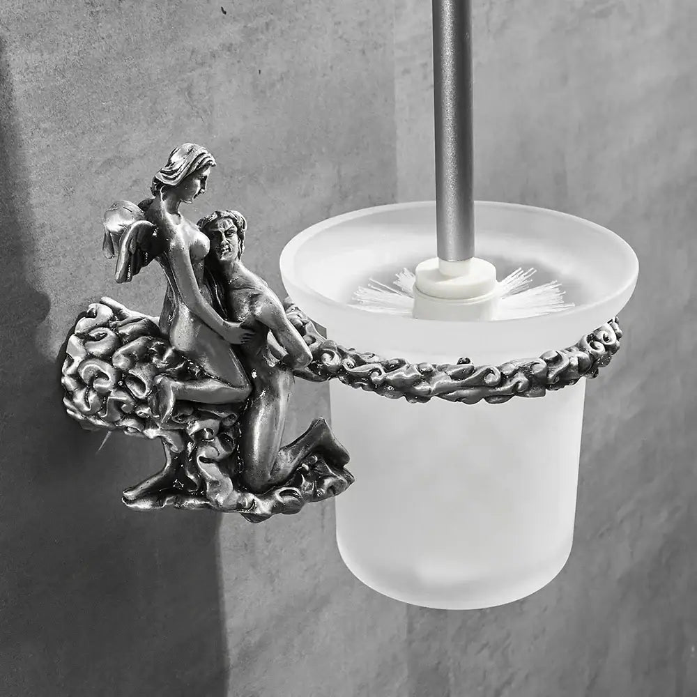 Antique silver-toned bathroom hardware set with ornate angel and cherub sculpture on frosted glass base