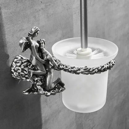 Antique silver-toned bathroom hardware set with ornate angel and cherub sculpture on frosted glass base