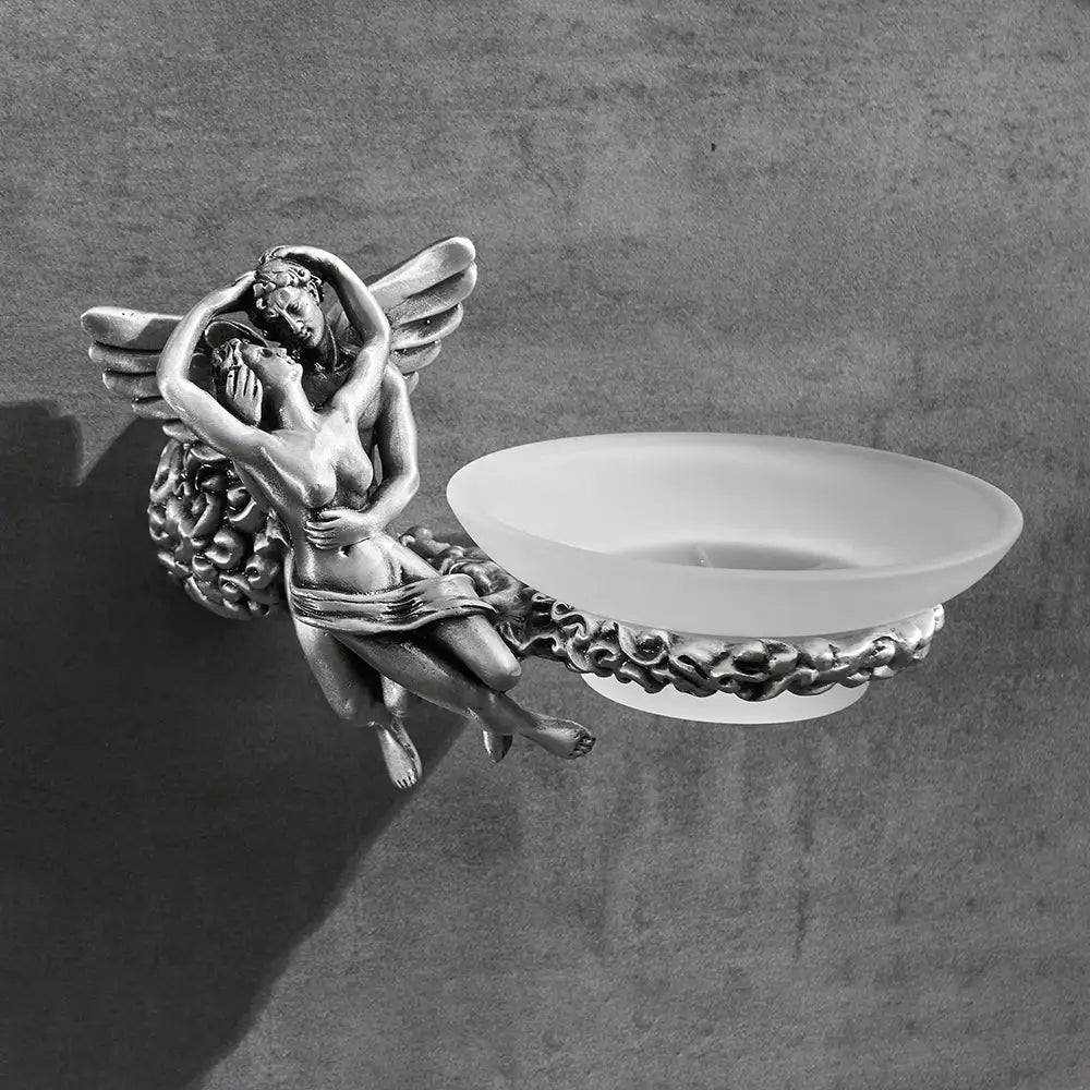Silver-toned angel and nymph figurine holding a frosted glass soap dish in romantic bathroom hardware set