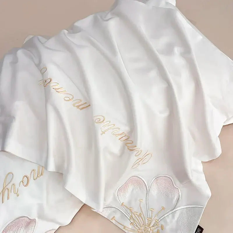 White satin robe with delicate gold and pink embroidered flowers butterfly design complements flowers butterfly bedding set