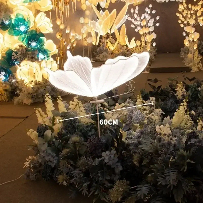 Romantic white and gold floor lamp with a glowing butterfly wedding decoration and translucent wings by decorbites
