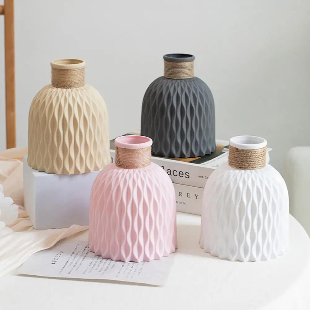 Set of four modern ceramic vases in beige gray pink and white with diamond patterns and twine collars for home decoration