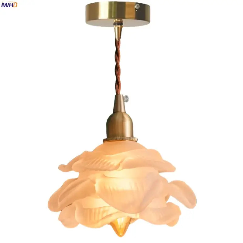Rose frosted white glass pendant lamp featuring a warm-toned translucent rose design with brass fixture and twisted cord