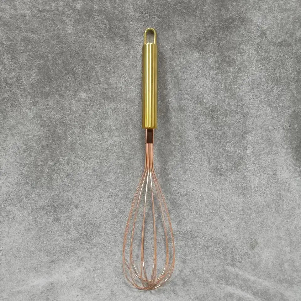 Rose gold metal egg beater whisk with sleek cylindrical handle and fine wire loops from decorbites gold steel set