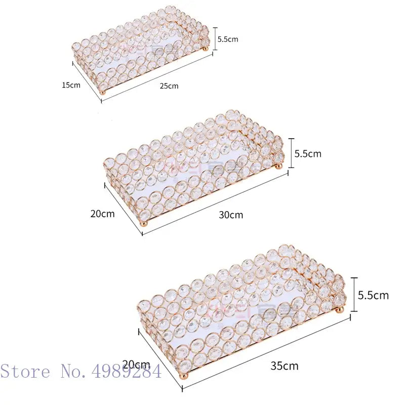 Set of three rose gold crystal glass mirror trays with gold-tone frames and crystal-encrusted edges in multiple sizes