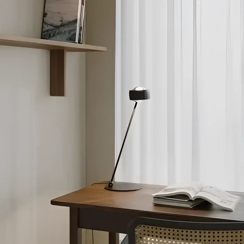 Black minimalist floor lamp with slender metal arm and circular head featured in decorbites designer fishing floor collection