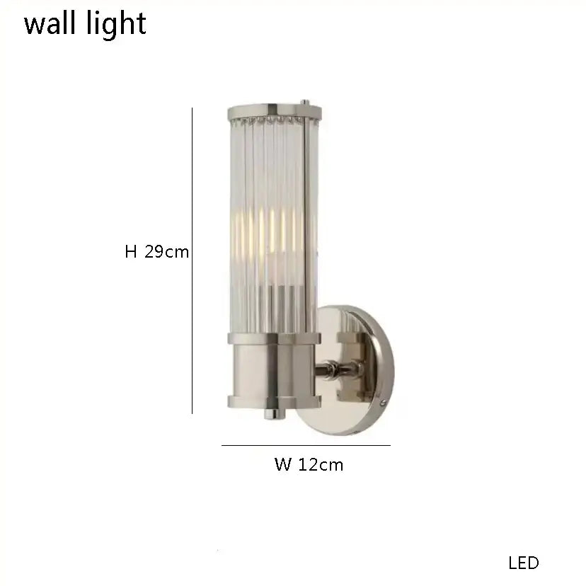 Modern brushed nickel wall sconce with cylindrical pink glass chandelier shade featuring vertical ridges and led light source