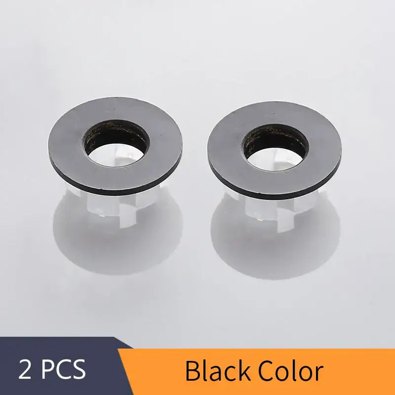 Black plastic mounting washers with central hole and ridged edge for decorbites brass sink overflow cover set inserts