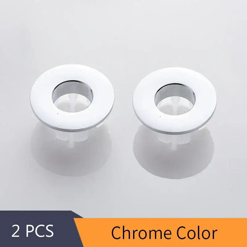 Chrome-colored circular plastic overflow cover with glossy white ring and metallic rim for decorbites brass sink overflow