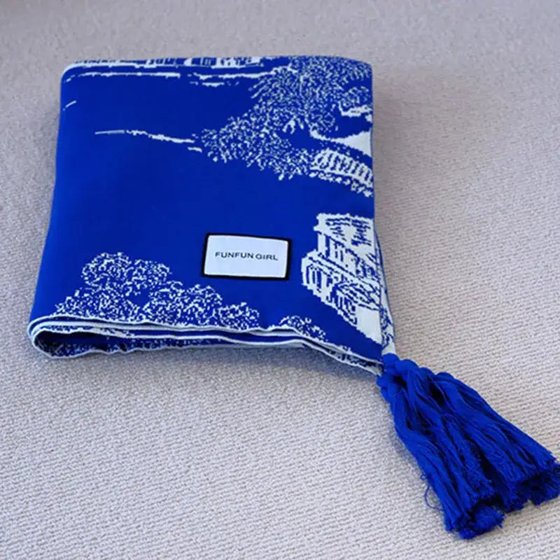 Royal blue and white knitted sofa blanket with tree and building pattern and tassel for living room throw