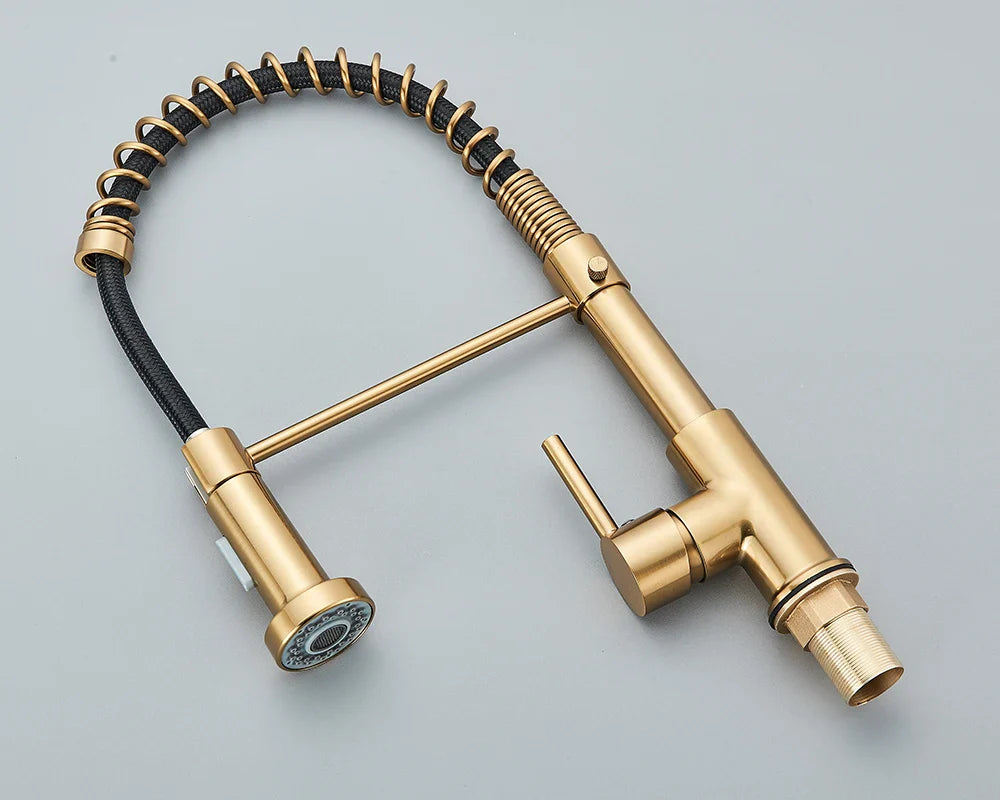 Brass-finished deck mounted kitchen faucet with flexible coiled black hose and pull-down spray head single hole design