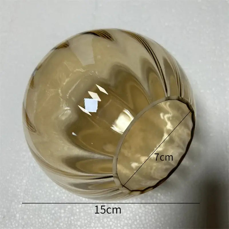 Translucent amber decorbites glass ball pendant with ribbed swirling pattern and 15cm diameter for living room decor