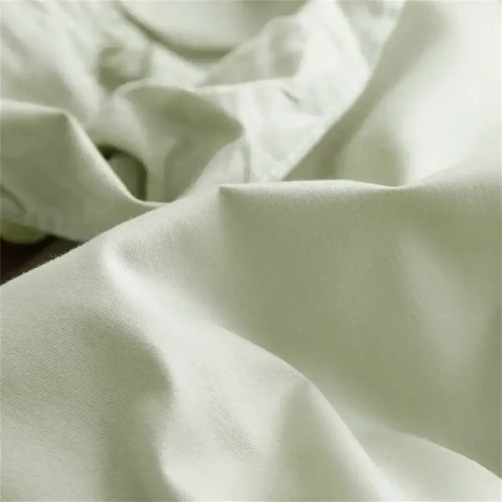 Soft off-white cotton fabric with gentle folds in decorbites light green ruffled egyptian cotton bedding set