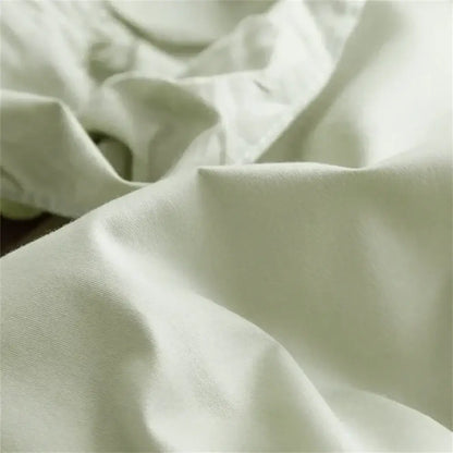 Soft off-white cotton fabric with gentle folds in decorbites light green ruffled egyptian cotton bedding set