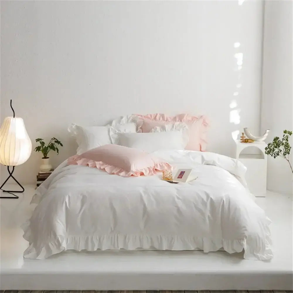 White ruffled bedding set with soft pink accent pillows made of light green egyptian cotton decorbites bedding set