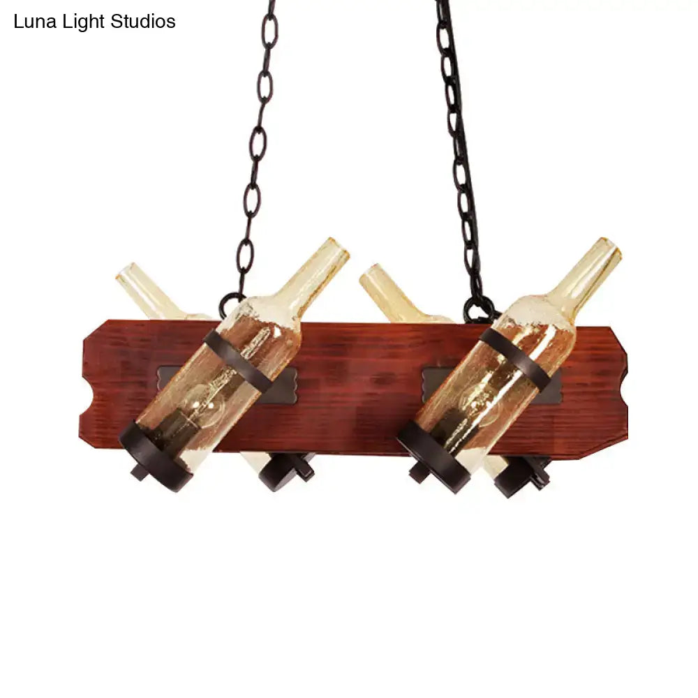 Rustic island lamp with frosted white and amber glass bottles suspended by chains on a brown wood arm fixture