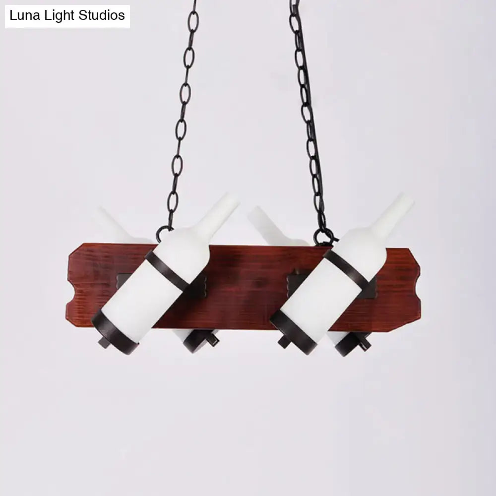 A rustic island lamp with a brown wood arm featuring two frosted white bottle-shaped glass shades with black bands