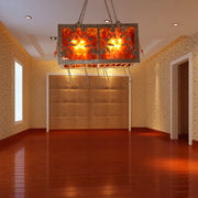 Rustic amber glass rectangular island light with metallic frame and intricate leaf designs for dining room lighting