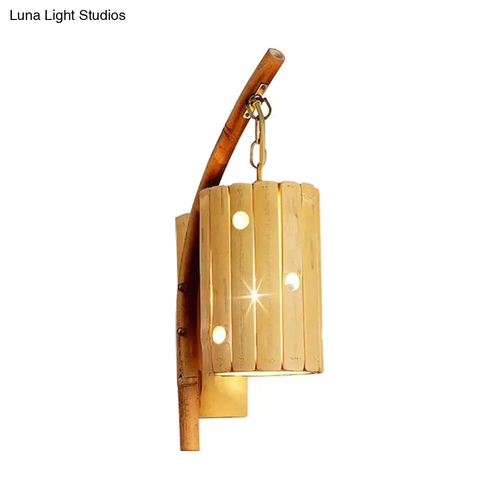 Rustic natural bamboo cylinder house sconce light fixture with vertical slats and circular cutouts for bedroom use