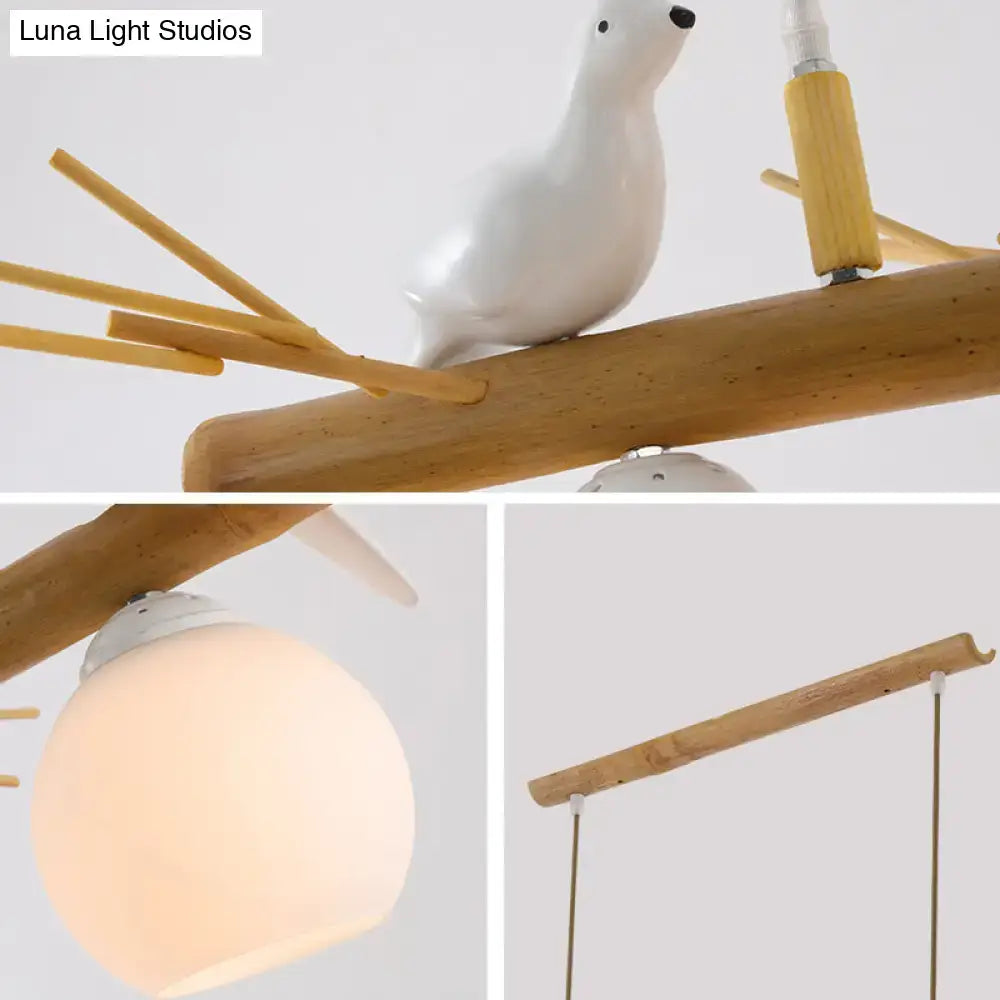 DecorBites modern cream glass wood pendant light fixture with white bird deco perched on bamboo dome island branch