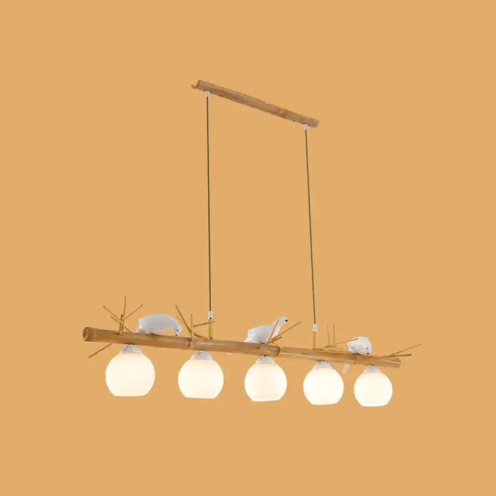 DecorBites modern cream glass wood light fixture with white bird deco and frosted globes for dome island spaces