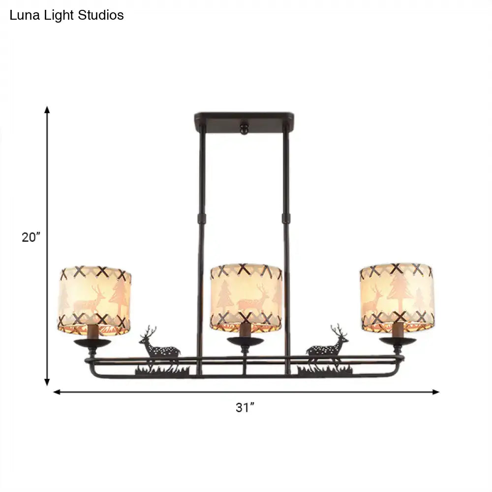 Rustic black metal deer chandelier with three warm-toned barrel shade shapes featuring deer silhouettes and cross-stitch detailing