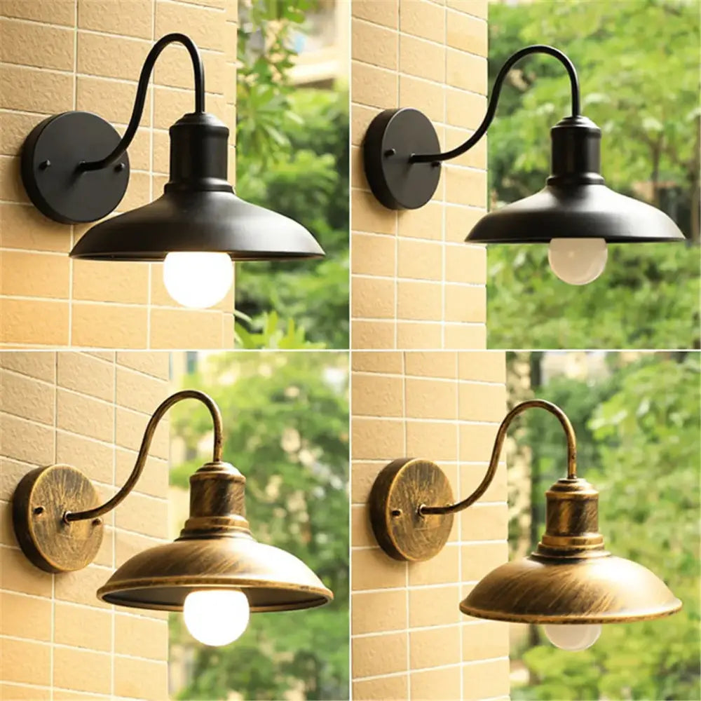 Rustic black gooseneck light fixture with black and antique brass curved arms and dome-shaped shades by decorbites black rustic
