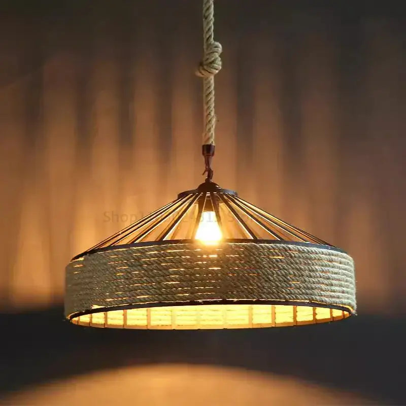 Rustic black iron pendant light with warm-toned woven rope-inspired detailing and braided cord pendant for kitchen use