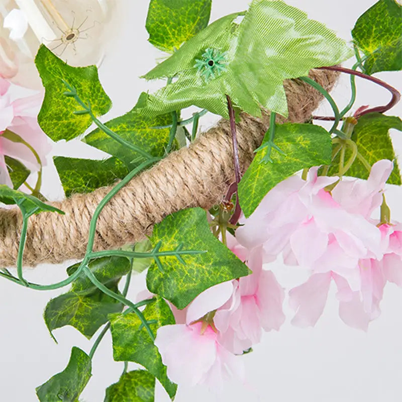 Decorbites black metal 4-light linear island lamp with hanging artificial floral wreath featuring pink blossoms and green leaves
