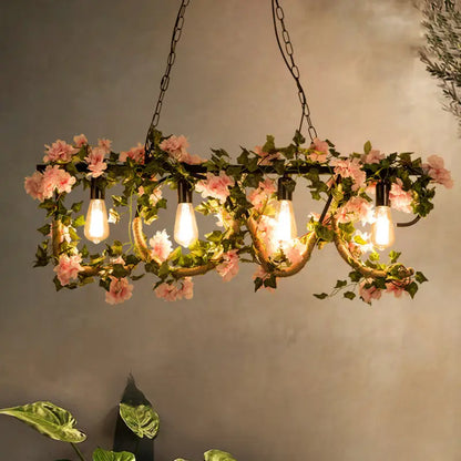 DecorBites™ black metal 4-light linear island lamp with wrought iron chandelier, exposed bulbs, and pink artificial vines