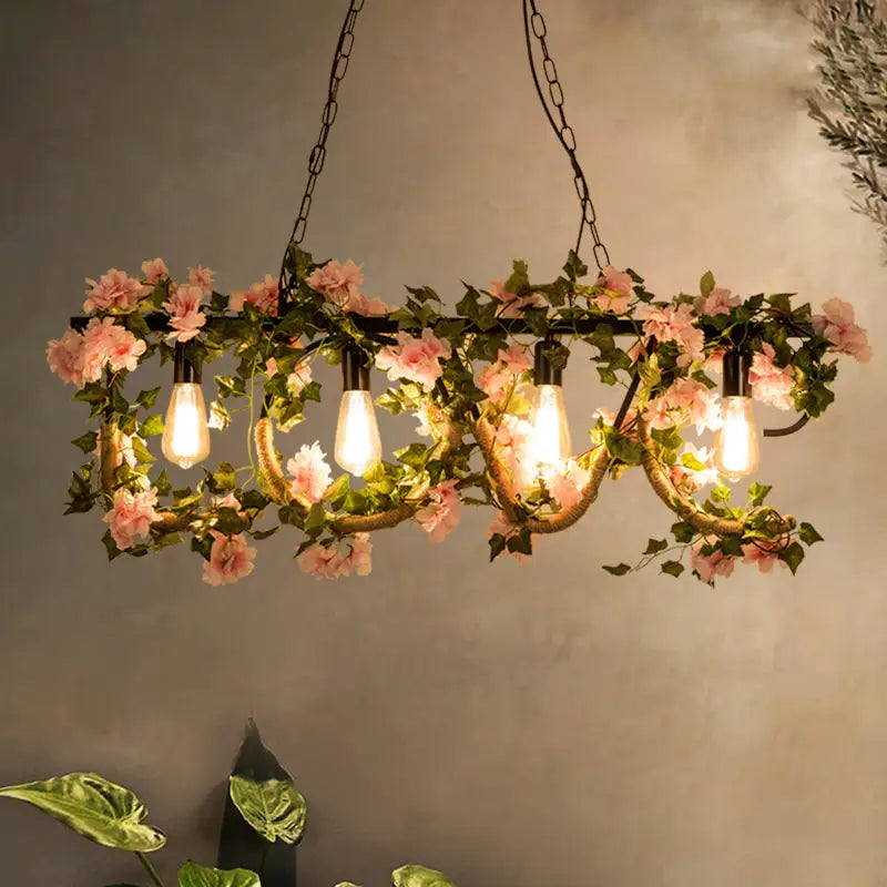 Decorbites black metal 4-light linear island lamp with pink artificial flowers and exposed edison bulbs in lodge style