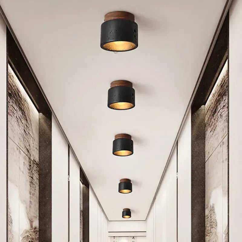 Rustic black travertine ceiling light with wooden top and warm golden interior glow for entrance hallway decorbites black travertine